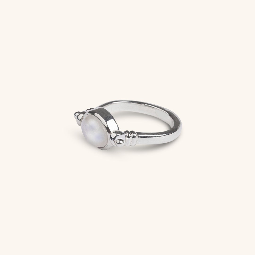 Silver ring with a moonstone on a white background