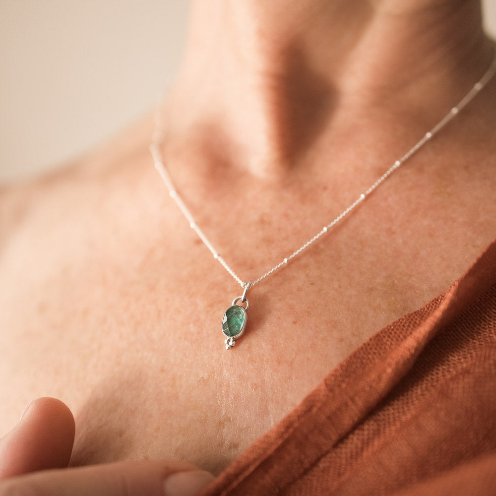 woman wearing blue tourmaline pendant on satellite chain