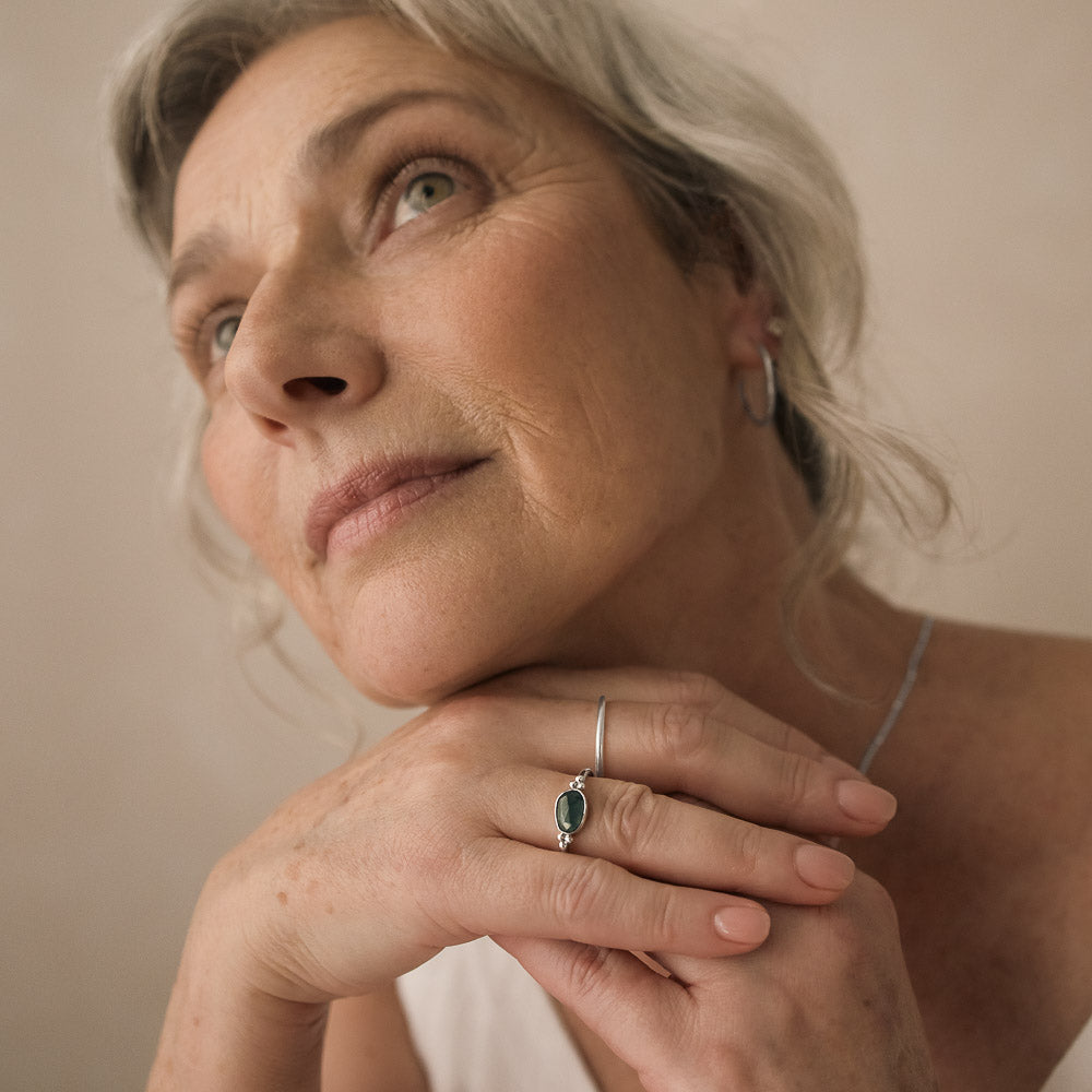 beautiful older woman wearing blue tourmaline ring