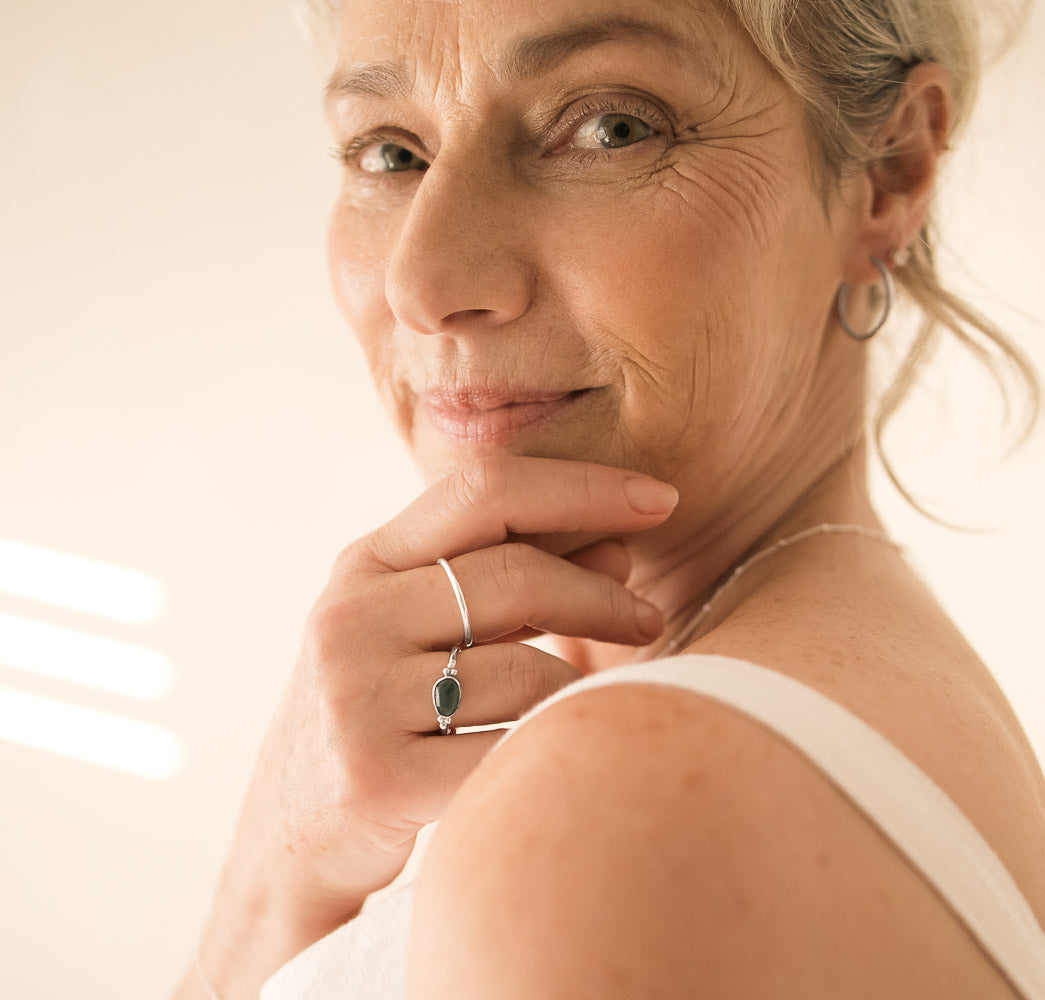 beautiful older woman wearing blue tourmaline ring