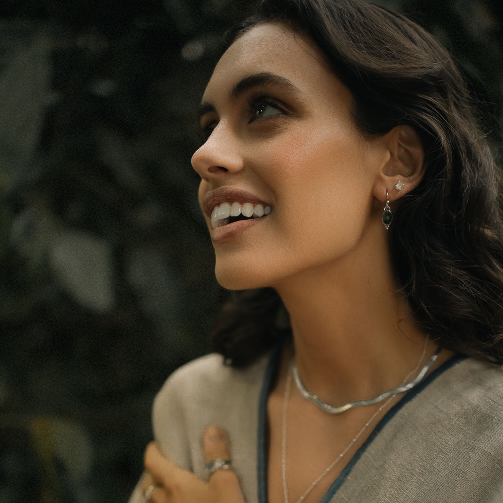 woman wearing green tourmaline earrings