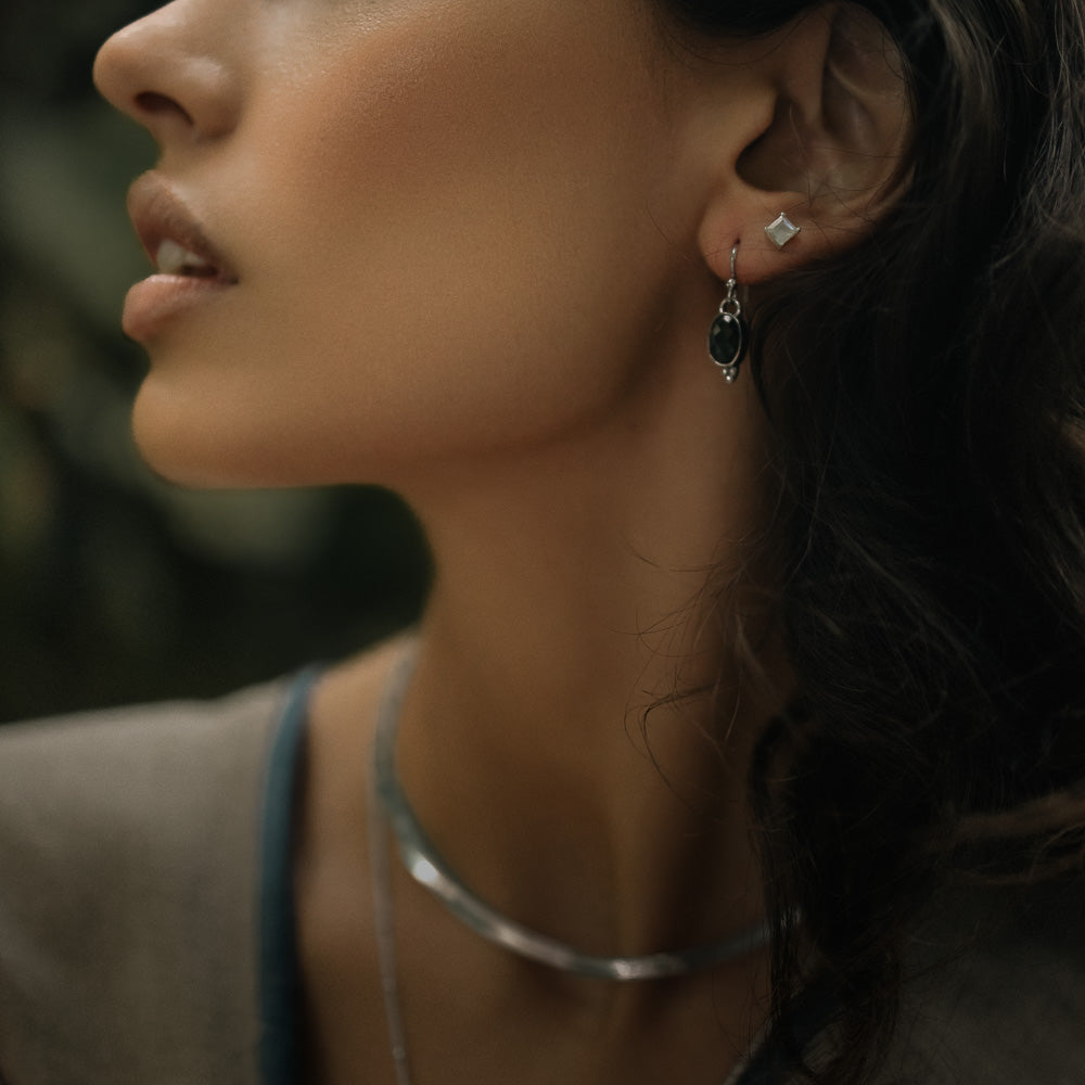 woman wearing green tourmaline earrings