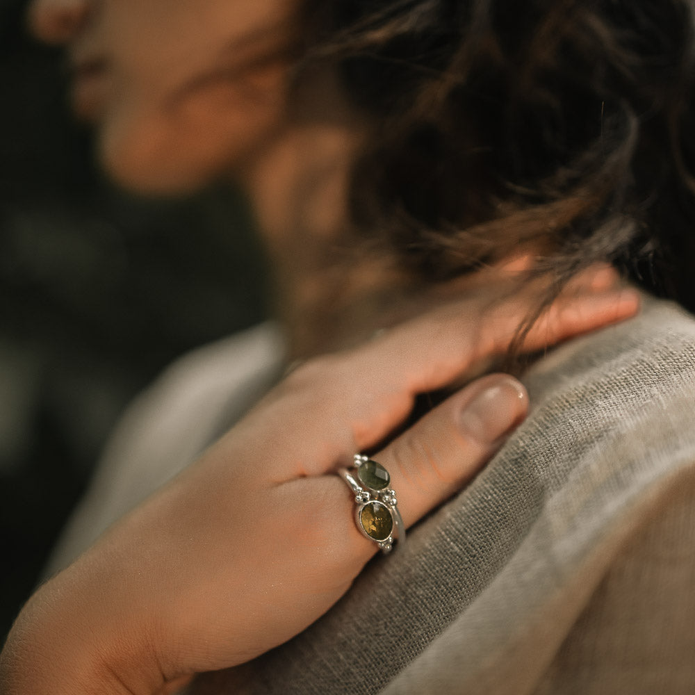 women wearing green tourmaline rings on finger