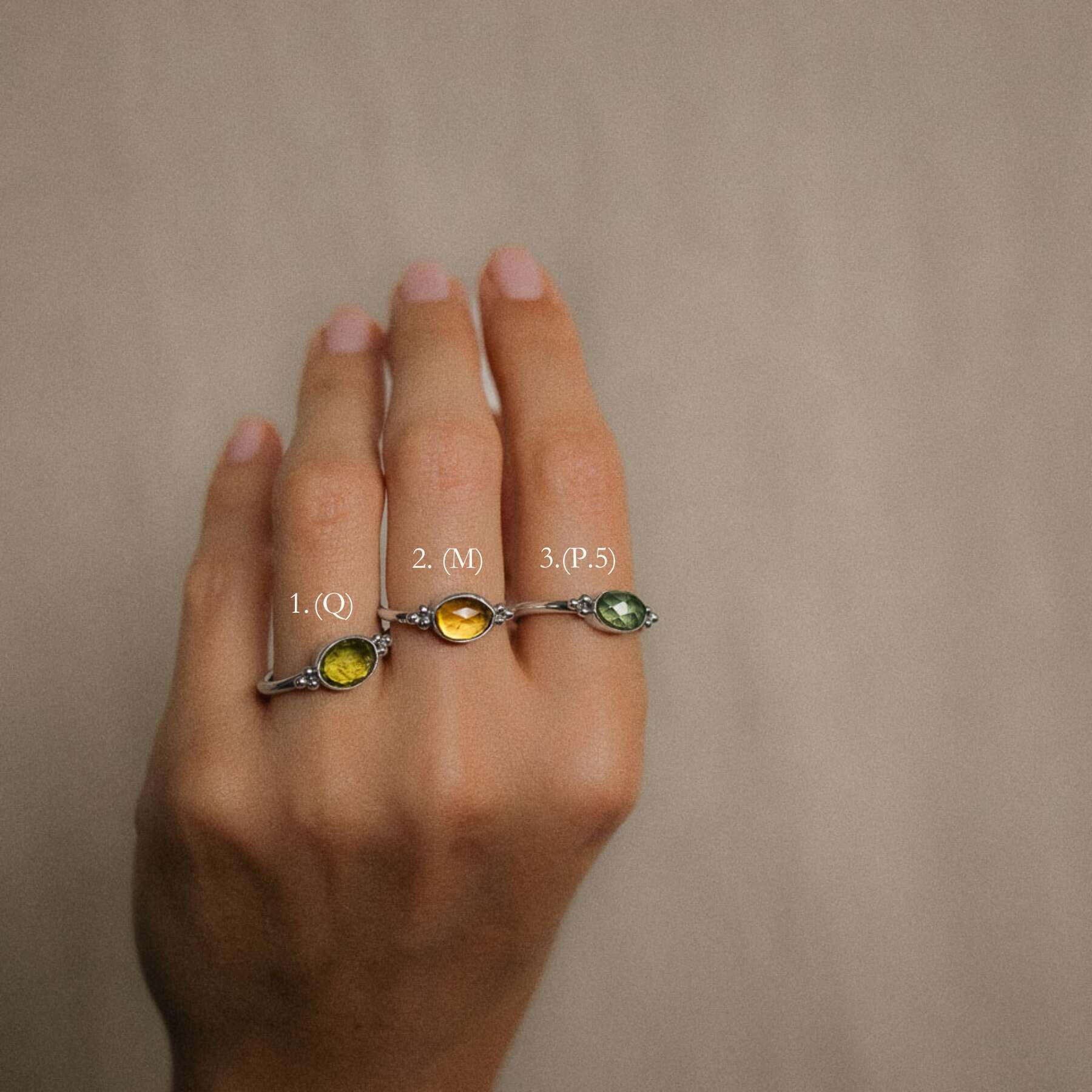 women wearing green tourmaline rings on fingers options