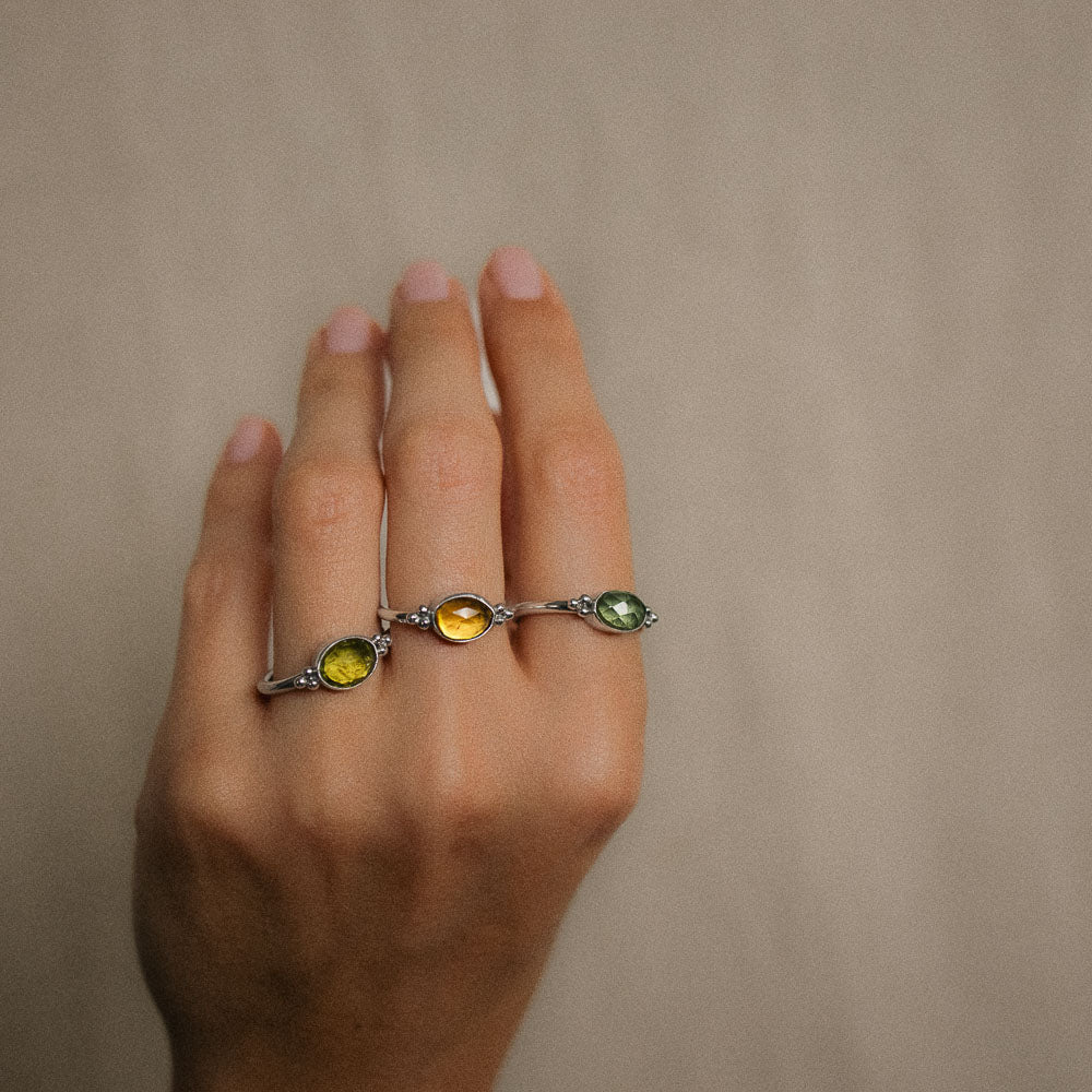 women wearing green tourmaline rings on fingers