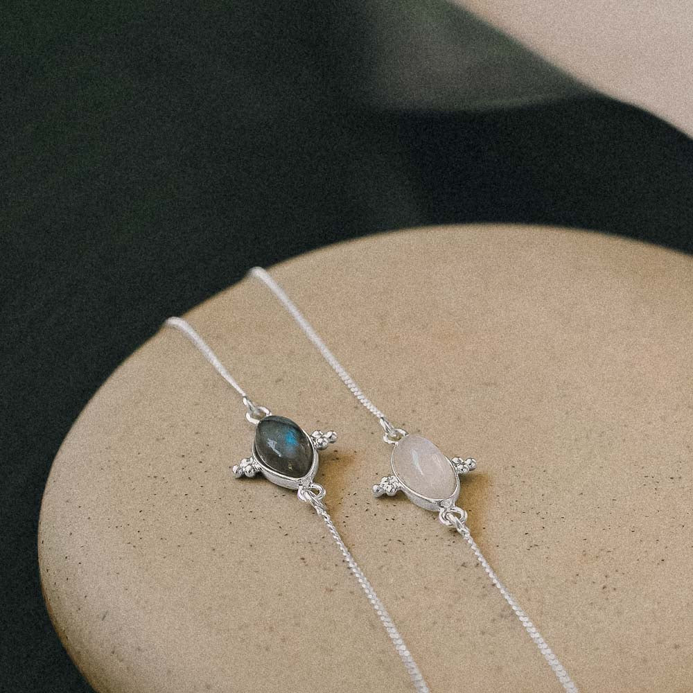 two gemstone bracelets resting on ceramic dish