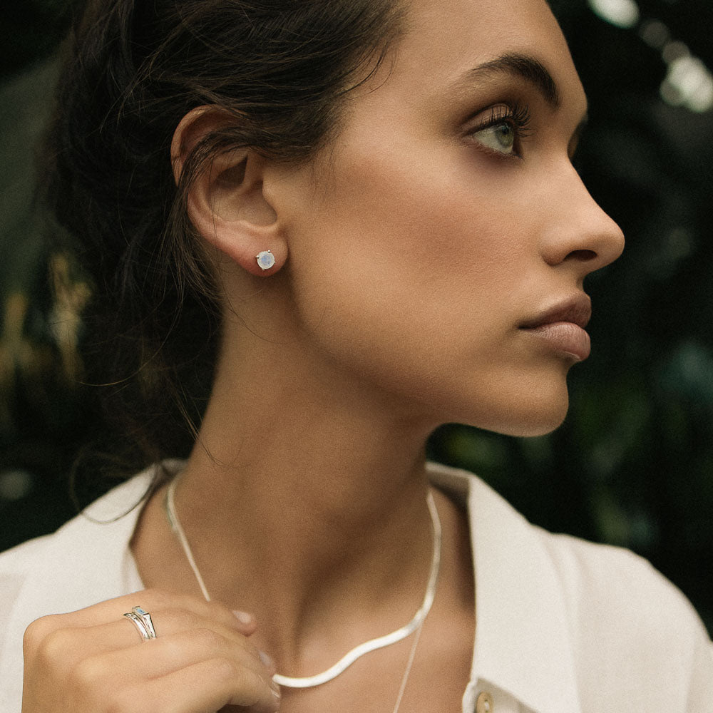 woman wearing round moonstone earring studs