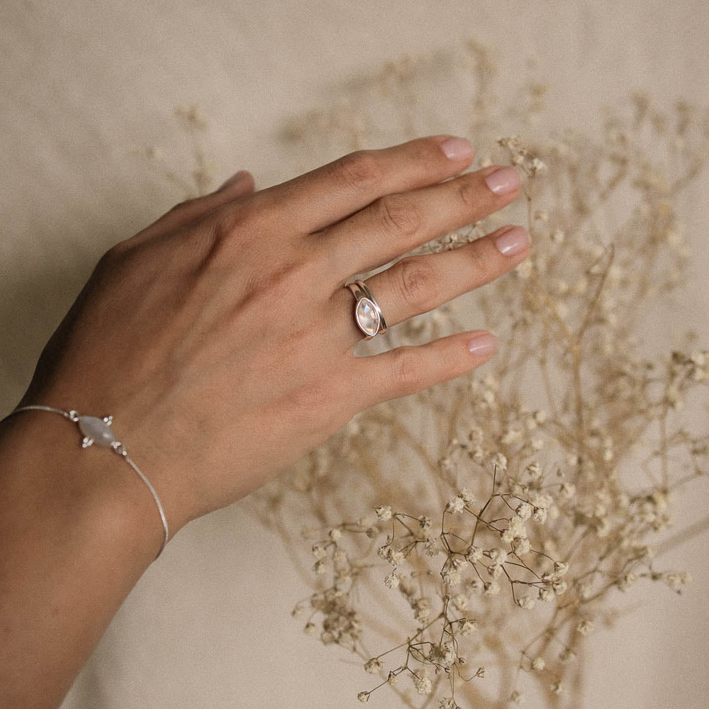a woman's hand wearing a moonstone marquise silver ring