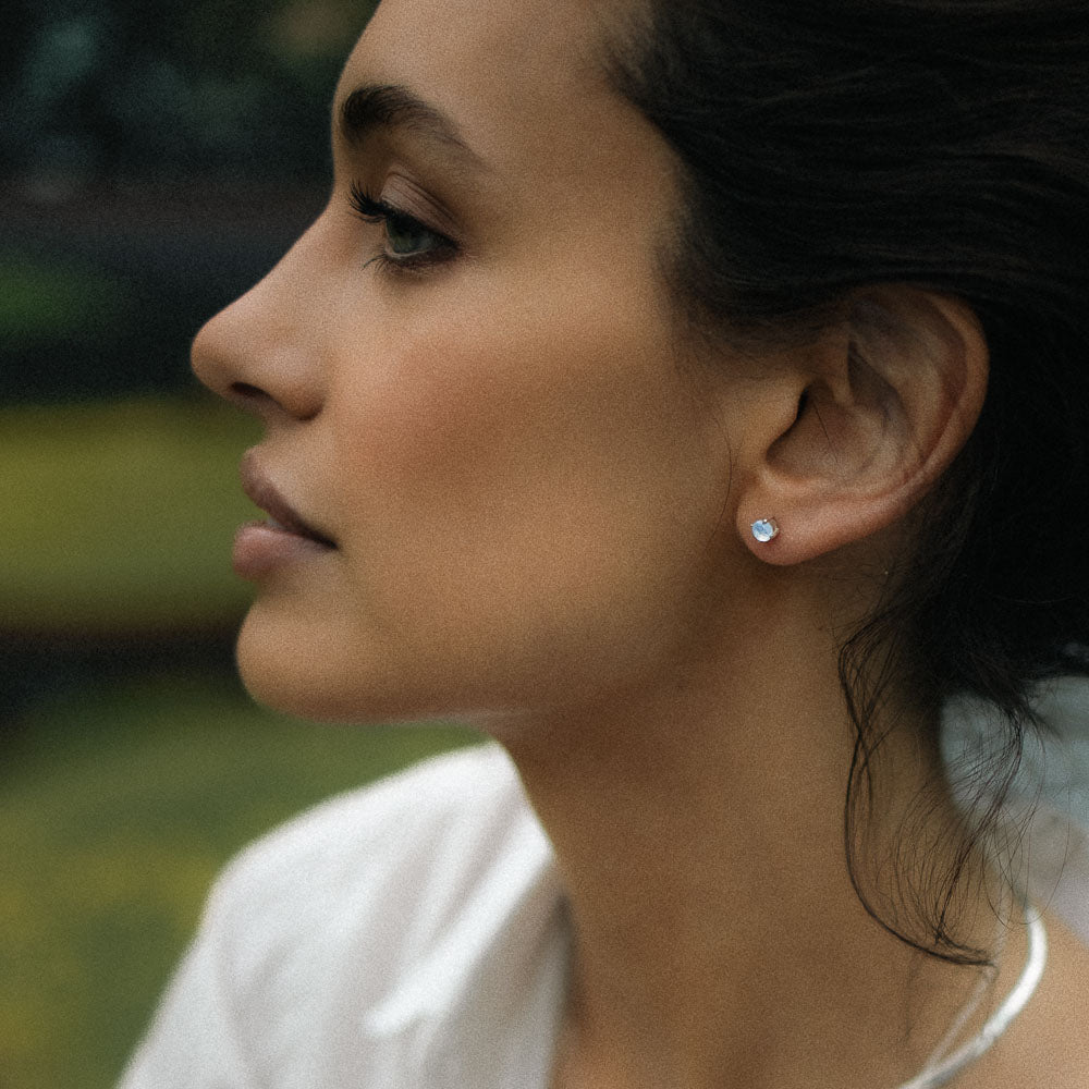 woman wearing round gemstone moonstone earring studs