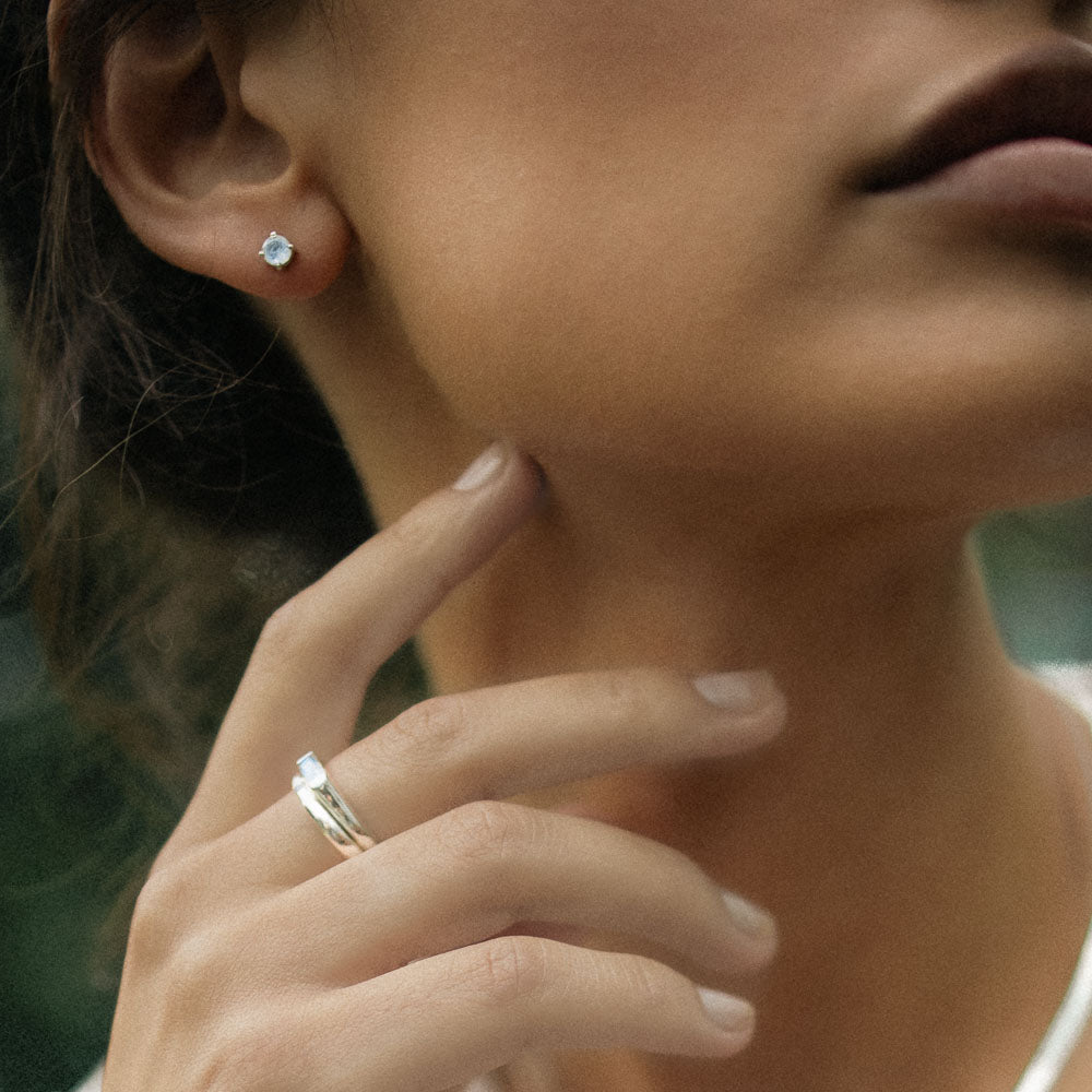 woman wearing round gemstone moonstone earring studs