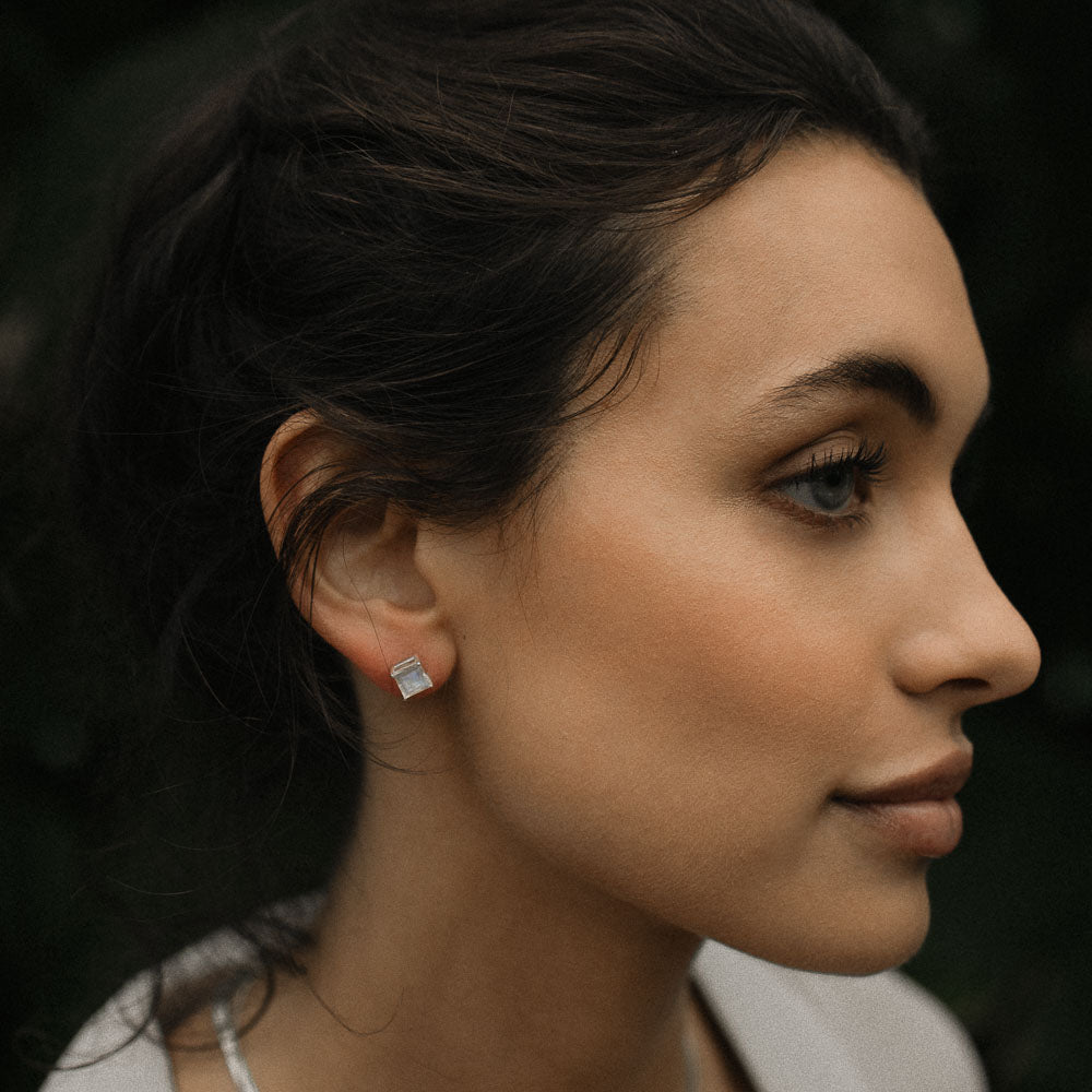 woman wearing square moonstone earring studs