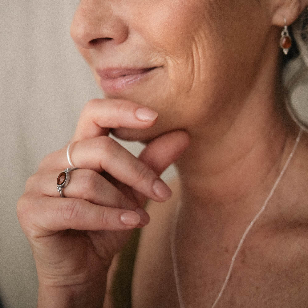 orange tourmaline ring on beautiful older women