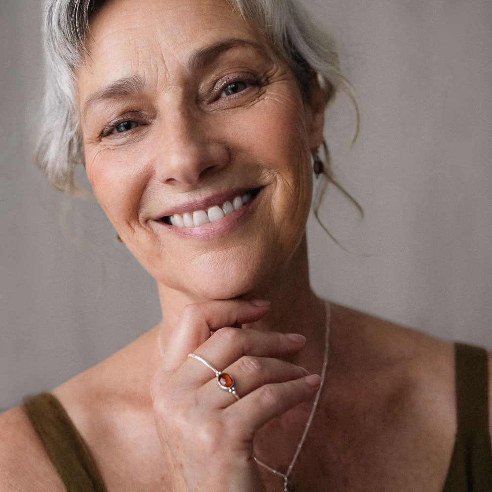 orange tourmaline ring on women's finger