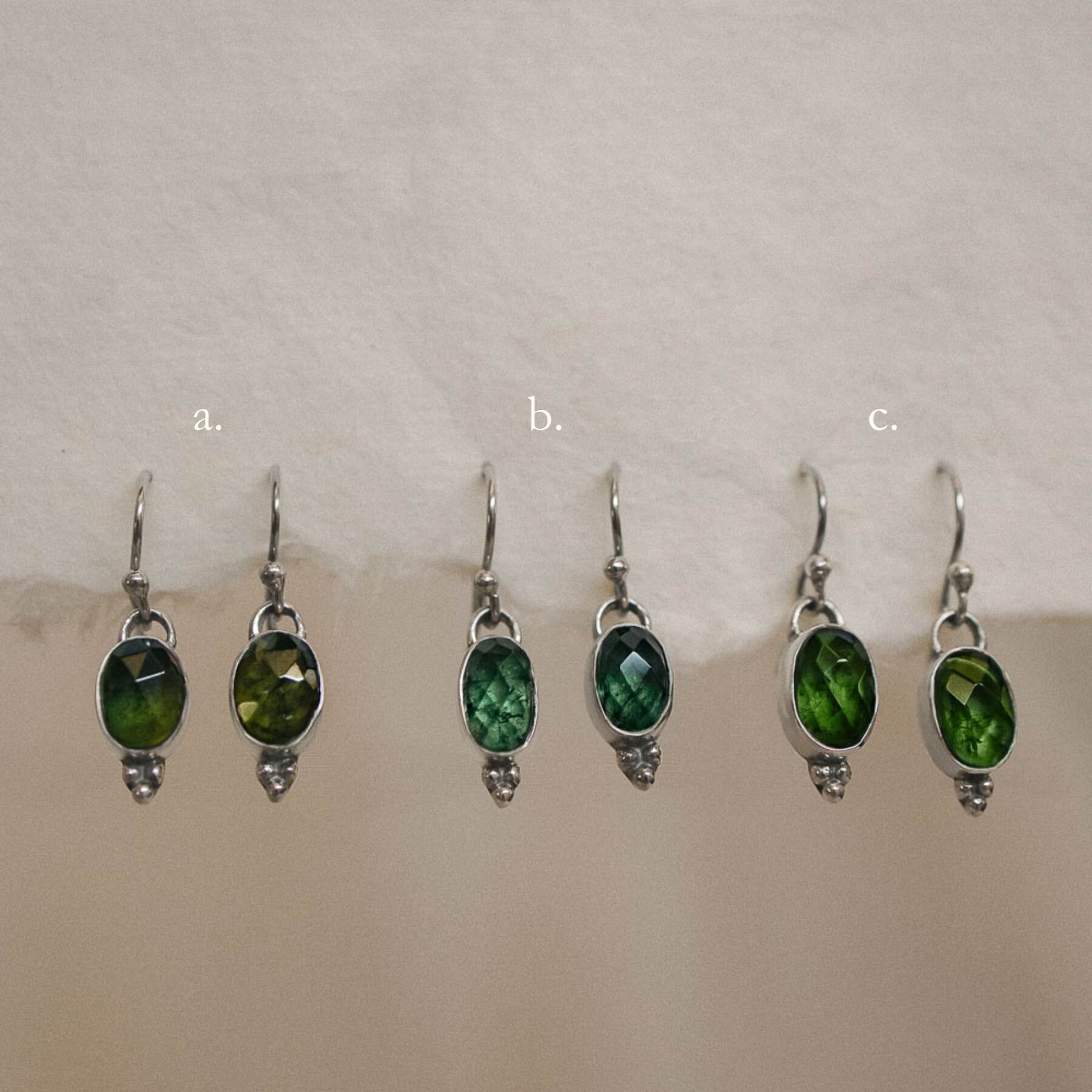 pairs of green tourmaline earrings on handmade paper options