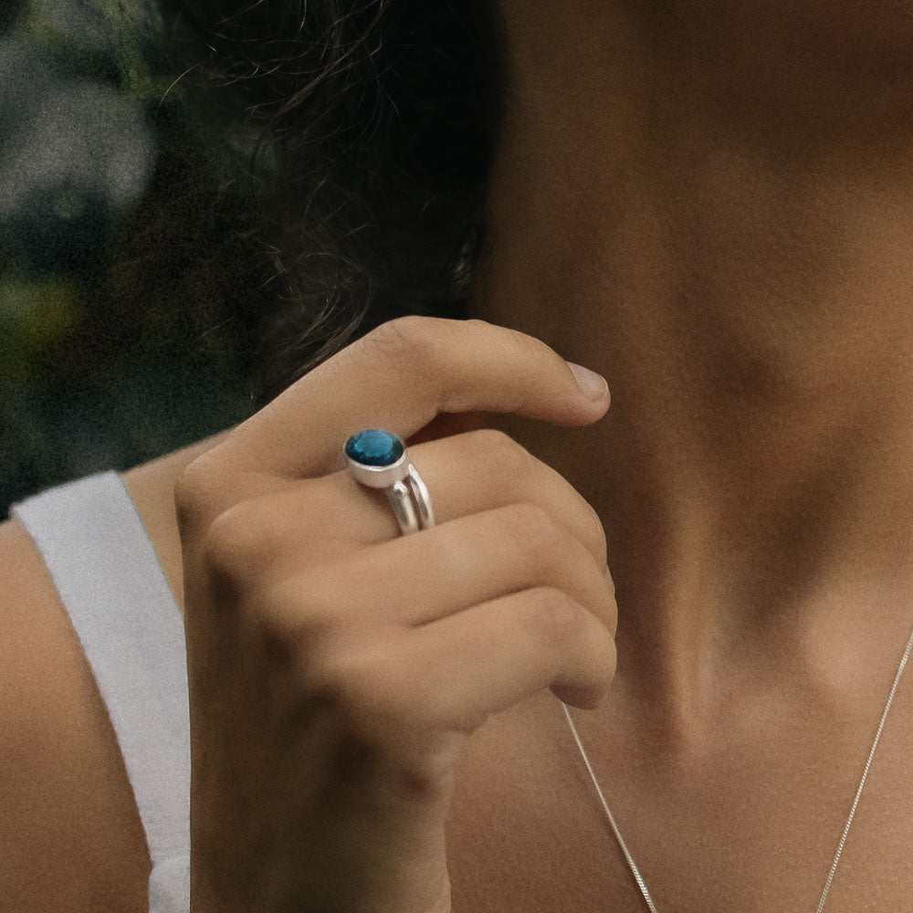 a silver oval gemstone labradorite ring on finger