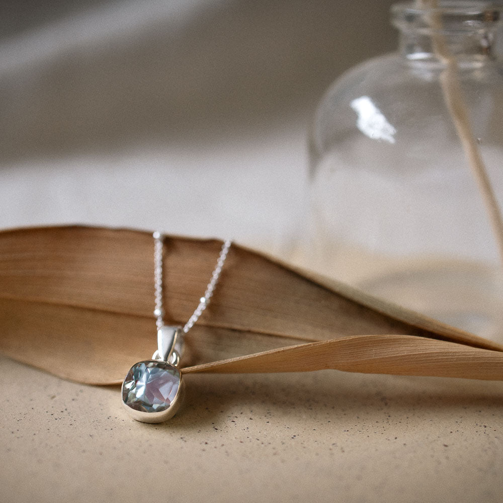 square faceted green amethyst pendant set in sterling silver bezel on chain