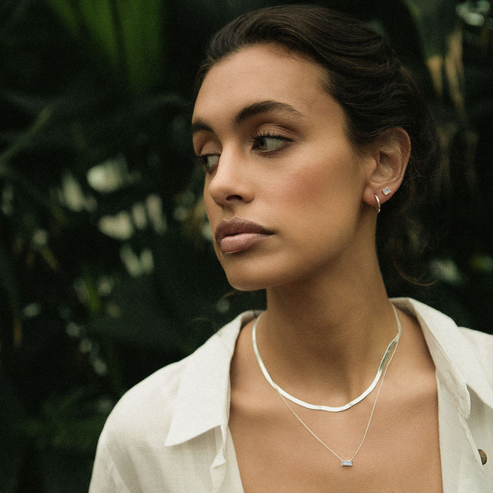 woman wearing square gemstone moonstone earring studs