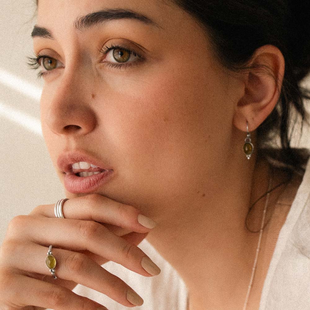 women wearing yellow tourmaline ring and earrings