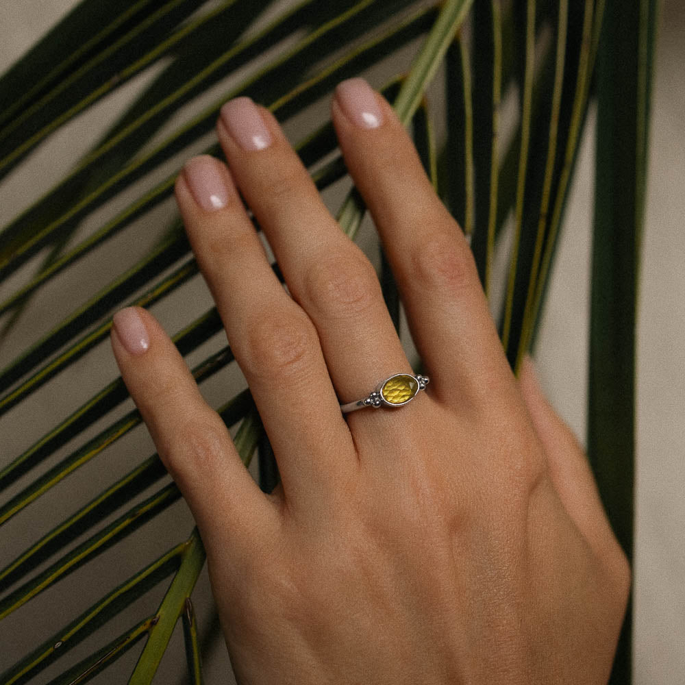 women wearing yellow tourmaline ring with palm fronds