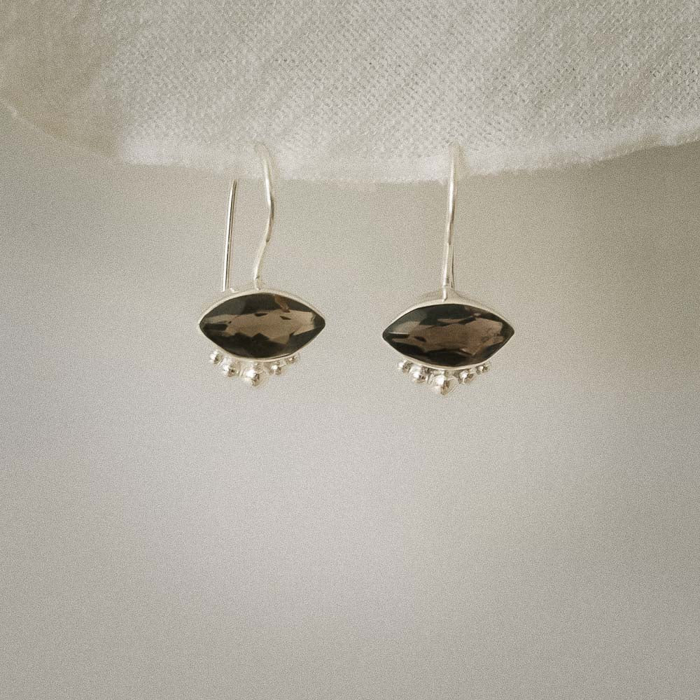 Pair of silver earrings with natural Smokey Quartz stones on a white background
