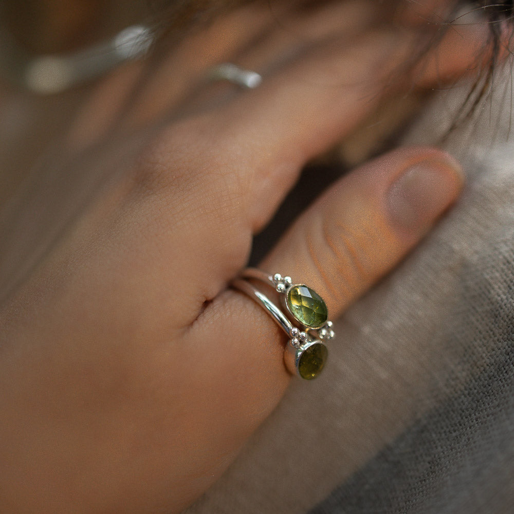 women wearing green tourmaline rings on finger