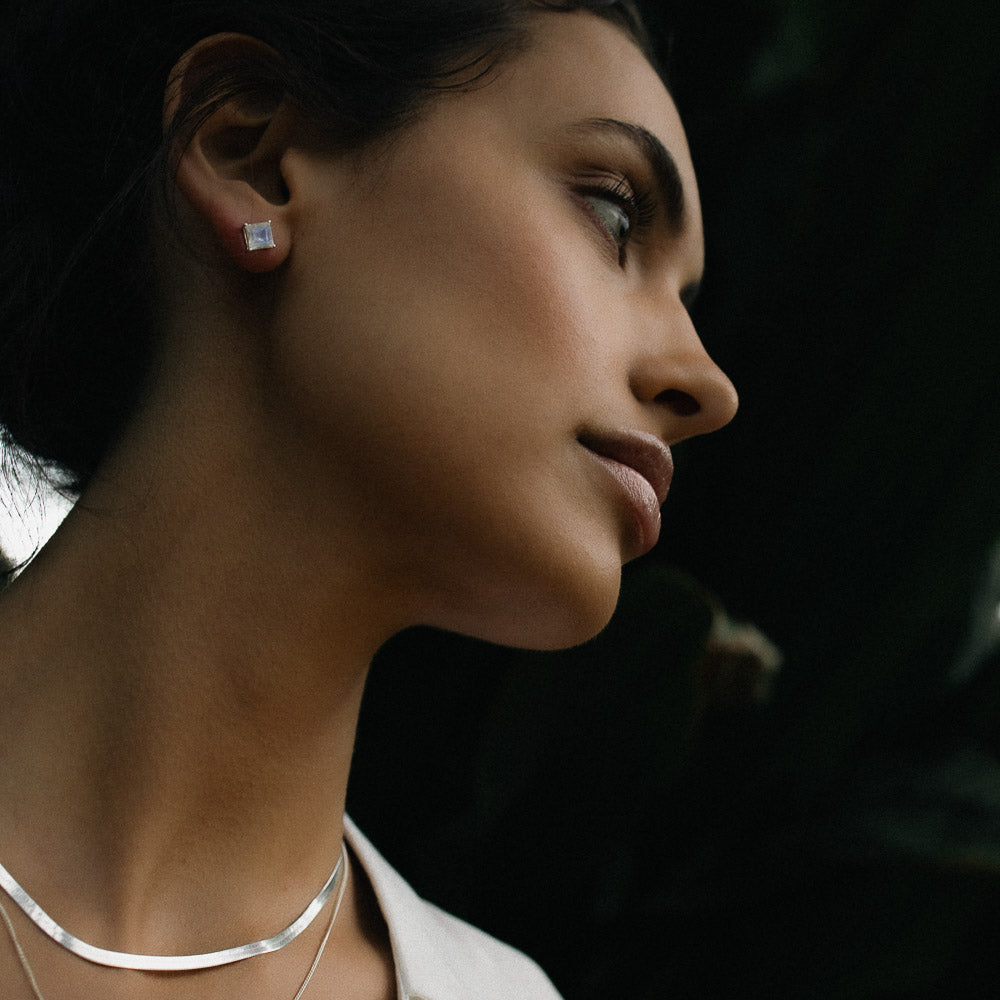 woman wearing square moonstone earring studs