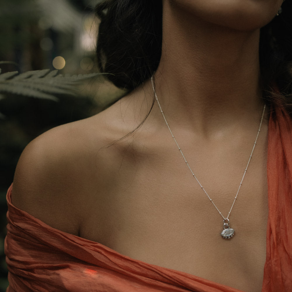 woman wearing marquise moonstone gemstone pendant on satellite chain