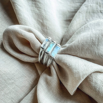 three large baguette moonstone silver rings on linen