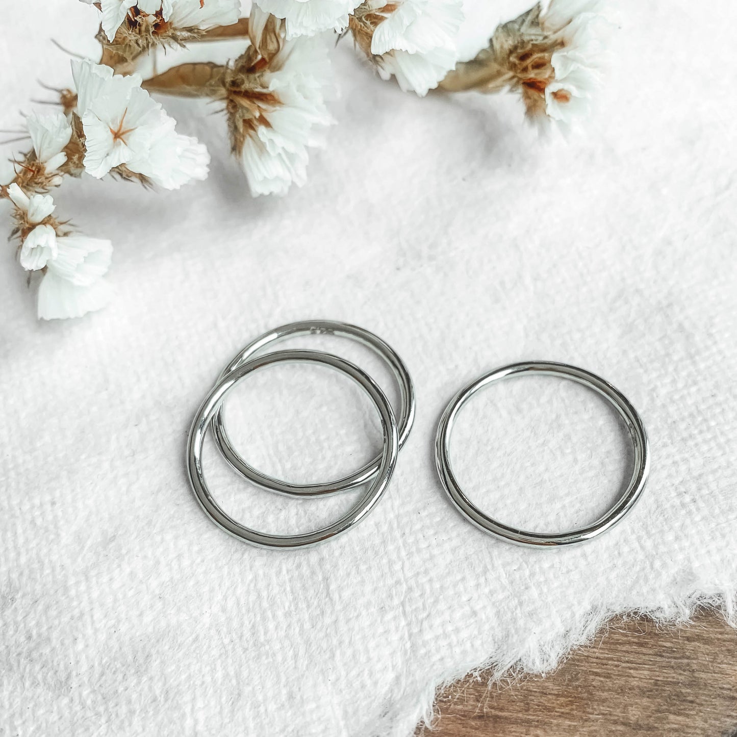 three sterling silver stacking rings on white paper