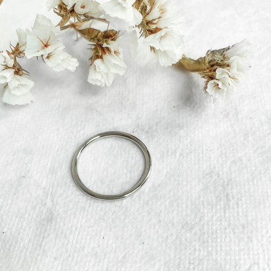 sterling silver stacking ring on white paper