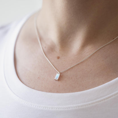 vertical rainbow moonstone silver necklace pendant on model neck